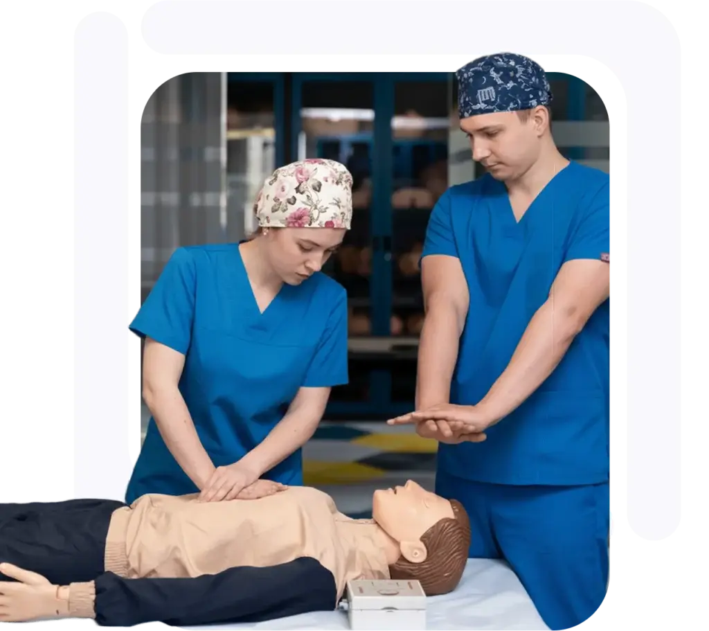 Two medical professionals performing CPR on a training mannequin during a training session.